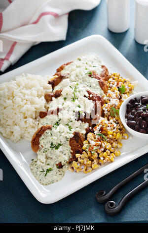 Verde pork with rice, black beans and elote corn Stock Photo