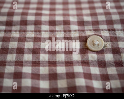 close-up of mans plaid checkered shirt with white button Stock Photo
