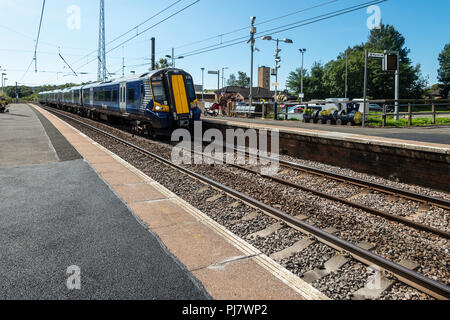 A Siemens Class 380 Desiro electric multiple-unit train (ScotRail run by Abellio) arriving at the halt in Dalry, North Ayrshire en route to Glasgow. Stock Photo