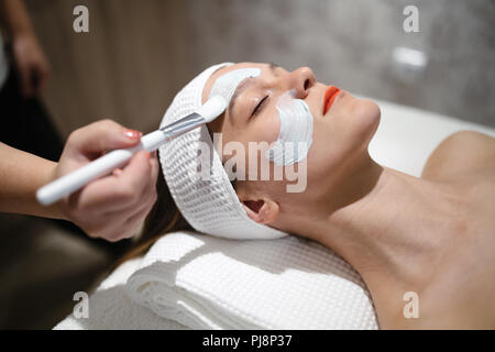 Masseur applying face mask Stock Photo