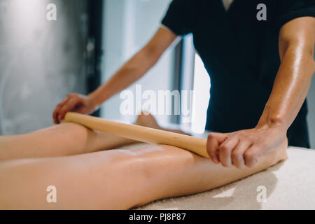 Masseur massaging masseuse during therapeutic tretment Stock Photo