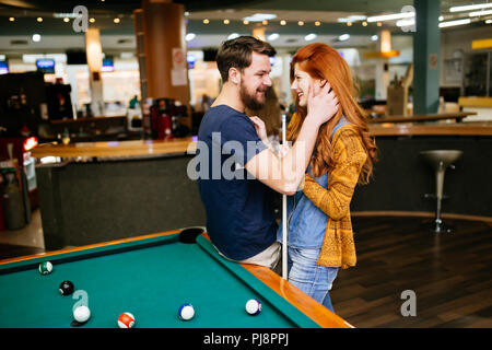 Couple hugging in snooker bar Stock Photo