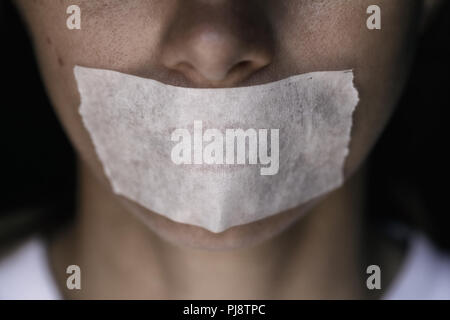 Censorship in the Modern World: A man's mouth sealed with an adhesive tape, close-up Stock Photo