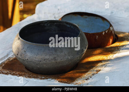 Old rustic cast iron standing on the stove, close-up Stock Photo