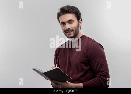 Young intern making some notes working in lawyer office Stock Photo