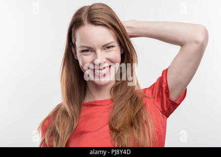 Beaming red-haired woman feeling extremely happy after getting promotion Stock Photo