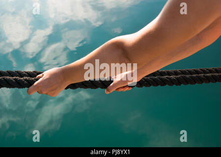 Women hands pull a strong blue rope tied to a birch tree. Professional zip  line or cable car installation. Time for fun and relaxation. Family weekend  Stock Photo - Alamy