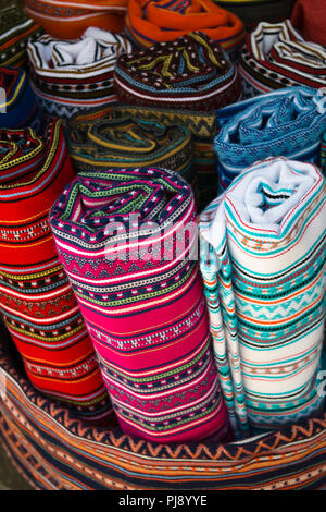 Display of multicolored traditional blankets in a market, Crete, Greece Stock Photo