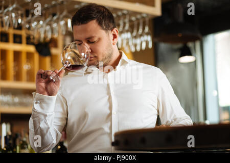 Nice good looking man holding a glass with red wine Stock Photo