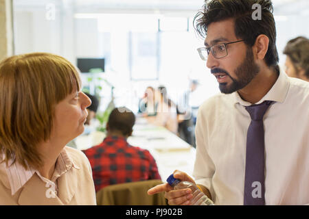 Serious business people talking in office Stock Photo