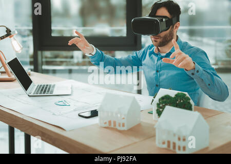 Nice pleasant man using 3d glasses Stock Photo