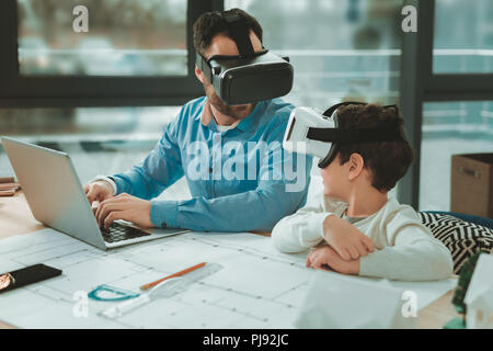 Pleasant nice father and son using modern technology Stock Photo