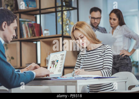Busy two colleagues immersing in work Stock Photo
