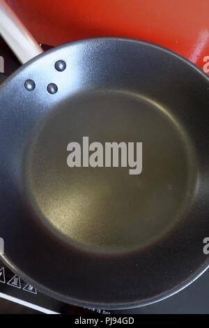 Empty Frying Pan on a Induction Hob Stock Photo
