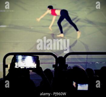 viewer photographs some girls while they perform an exercise in the gym class Stock Photo