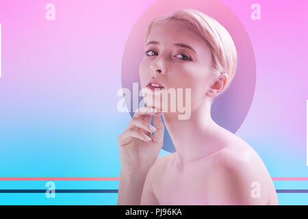 Blonde girl touching her chin and looking calm Stock Photo