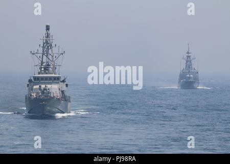 ARABIAN GULF (July 5, 2018) The Cyclone-class coastal patrol ship USS Hurricane (PC 3) executes tactical maneuvers at sea with the Qatari Emiri navy ship Damsah (Q01) during a bilateral passing exercise. USS Hurricane is forward deployed to the U.S. 5th Fleet area of operations in support of naval operations to ensure maritime stability and security in the Central region, connecting the Mediterranean and the Pacific through the western Indian Ocean and three strategic choke points. Stock Photo