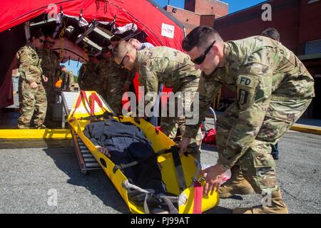 U.S. Army soldiers assigned to the 287th Engineer Detachment, train alongside Firefighters with the New York City Fire Department (FDNY)  at the FDNY Fire Academy on Randall's Island in New York City, New York, July 9, 2018. The FDNY along with U.S. Army North and U.S. Army Northern Command is conducting a joint exercise simulating a Chemical, Biological, Radiological, and Nuclear (CBRN) event to maximize the appropriate response from first response. Stock Photo