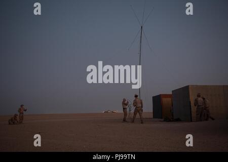 UNDISCLOSED LOCATION, MIDDLE EAST – U.S. Marines with 3rd Battalion 7th Marine Regiment attached to Special Purpose Marine Air-Ground Task Force, Crisis Response-Central Command set up communication equipment prior to a tactical recovery of aircraft and personnel (TRAP) exercise July 9, 2018. The exercise simulated the rescue of two downed pilots in a nigh- time environment. Stock Photo