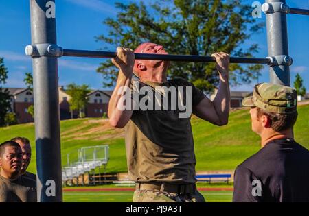 A paratrooper assigned to 5th Squadron, 73rd Calvary Regiment, 3rd Brigade Combat Team, 82nd Airborne Division executes pull-ups as part of the 1st Sgt. Funk Deployment Readiness Exercise July 10, 2018 at Fort Bragg, North Carolina. The 1st Sgt. Funk DRE tests unit readiness by testing paratroopers on range operations, physical fitness, medical skills and other command programs. Stock Photo