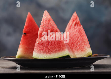 Three sliced slices of a watermelon on a table, close-up Stock Photo