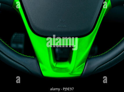 Close up view of steering wheel with green stiching, Black leather car interior design. Car interior details. Car detailing Stock Photo