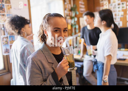 Portrait confident businesswoman drinking tea Stock Photo