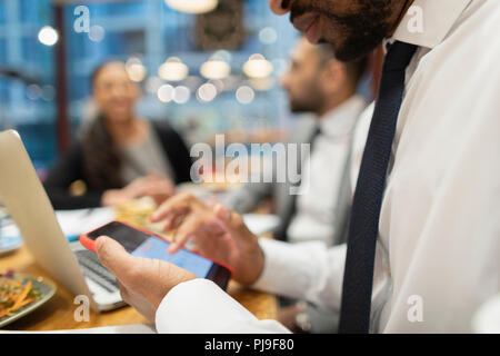 Close up businessman using smart phone in cafe Stock Photo