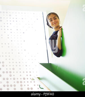 Portrait smiling high school girl in stairway Stock Photo