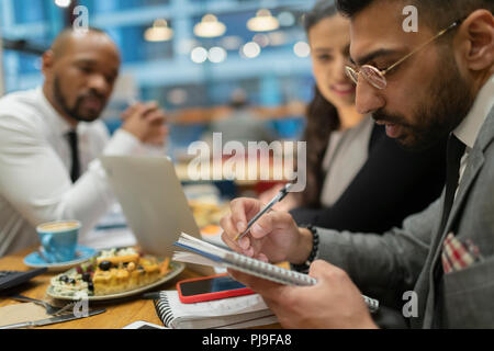 Business people writing, working in cafe Stock Photo