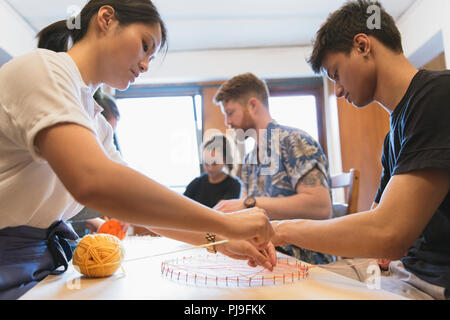 People making string art project Stock Photo