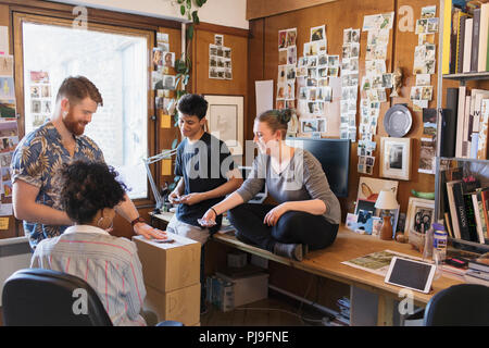 Creative designers playing cards in office Stock Photo