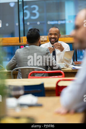 Businessmen talking, working in cafe Stock Photo