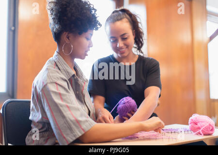 Smiling women doing string art project Stock Photo