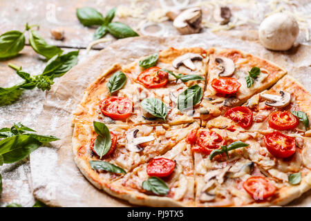Tasty pizza with tomatoes and mushrooms, close up Stock Photo