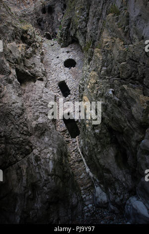 Culver Hole is a walled-up cave on the sheer limestone cliffs of the Gower coastline near Port Eynon.  Some local tales tell of it's use as a smuggler Stock Photo