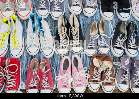 Converse trainers pattern. Converse trainers for sale on a stall at a vintage retro festival. UK Stock Photo