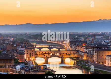 View of Florence at sunset with the Ponte Vecchio bridge over the Arno River Stock Photo