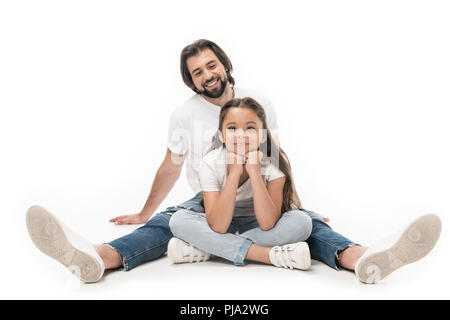 cheerful father and little daughter in white shirts and jeans isolated on white Stock Photo