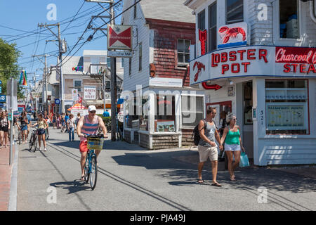 People walking and biking on Commercial Street in Provincetown, Massachusetts, Cape Cod, USA. Stock Photo