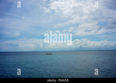 iconic holiday picture with stormy clouds and boat on sea Stock Photo