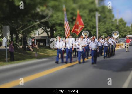 Marine Corps League honor guard members and Soldiers from the New Jersey National Guard's 63rd Army Band perform in the Historic Smithville Fourth of July parade in Smithville, N.J., July 4, 2018. This annual parade is the largest in the state. This image was captured with a tilt shift lens. Stock Photo