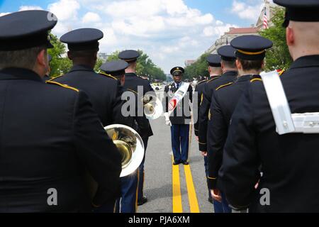 WASHINGTON —  Sgt. Andy Waiters, drum major, 257th Army Band, District of Columbia Army National Guard, inspects the formation in preparation for the Independence Day parade along Constitution Avenue on July 4, 2018, in Washington, D.C. The parade showcased other ceremonial units to include the U.S. Army Band, Joint Color Guard and the Military District of Washington’s Fife and Drum Corps. Stock Photo