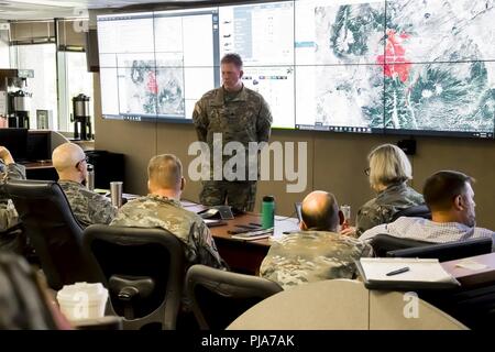 United States Army Lt. Col. Todd Stansbury, commander of Task Force Aviation, under Joint Task Force - Centennial, briefs JTF-C Commander U.S. Air Force Brig. Gen. Gregory White, about the status and requirements of helicopter, refiueling, and helibase fire suppression systems, during a JTF-C Spring Fire Commander's update brief, July 3, 2018.    The CONG has supported the Spring Fire since July 1, 2018, providing capabilities to include: security personnel for traffic control points and roving patrols; two UH-60 Black Hawk helicopter crews and aircraft each equipped with aerial water buckets; Stock Photo