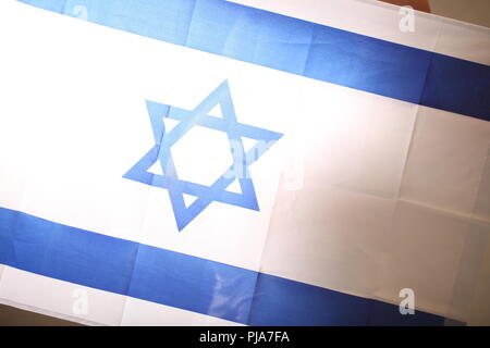 Fertility in Israel concept of a pregnant girl and Israel flag Stock Photo