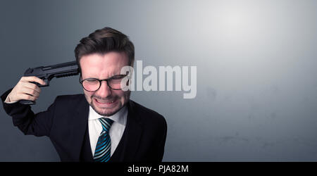 Young lost businessman man shooting his head with gun Stock Photo