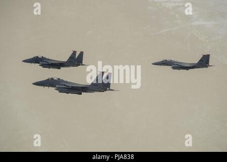 Three U.S. Air Force F-15E Strike Eagles, assigned to the 391st Fighter Squadron from Mountain Home Air Force Base, Idaho, fly over the Utah Test and Training Range July 3, 2018. The F-15E Strike Eagle is a dual-role fighter designed to perform air-to-air and air-to-ground missions. Stock Photo