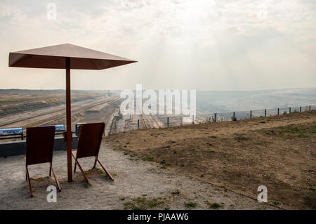 05 September 2018, Germany, Elsdorf: On the Terra Nova viewing platform, with a view of the Hambach open-cast lignite mine, there are two deck chairs with parasols. Photo: Christophe Gateau/dpa Stock Photo