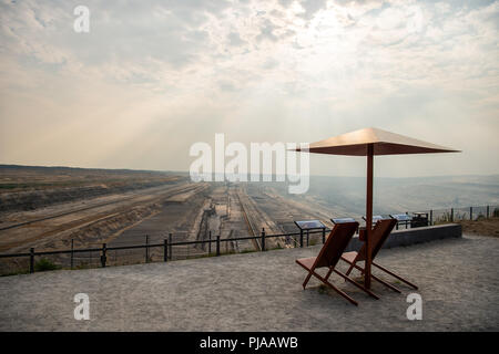 05 September 2018, Germany, Elsdorf: On the Terra Nova viewing platform, with a view of the Hambach open-cast lignite mine, there are two deck chairs with parasols. Photo: Christophe Gateau/dpa Stock Photo