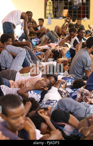 Tripoli. 5th Sep, 2018. Illegal migrants rest inside the Ganzour shelter after being transferred from another shelter near the airport due to clashes in Tripoli, Libya, Sept. 5, 2018. The UN Support Mission in Libya (UNSMIL) on Tuesday announced that the fighting parties in the capital Tripoli have signed a UN-sponsored agreement to end the fierce fighting in the city. Credit: Xinhua/Alamy Live News Stock Photo